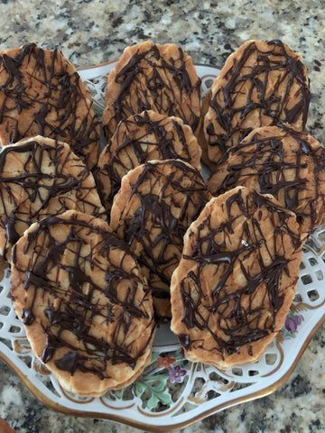 From scratch caramel sandwiched between a waffle butter cookie drizzled with chocolate